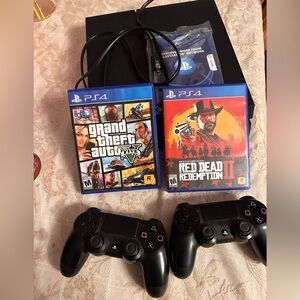PS4 console, 2x controllers, Grand Theft Auto PS4, and Red Dead Redemption II